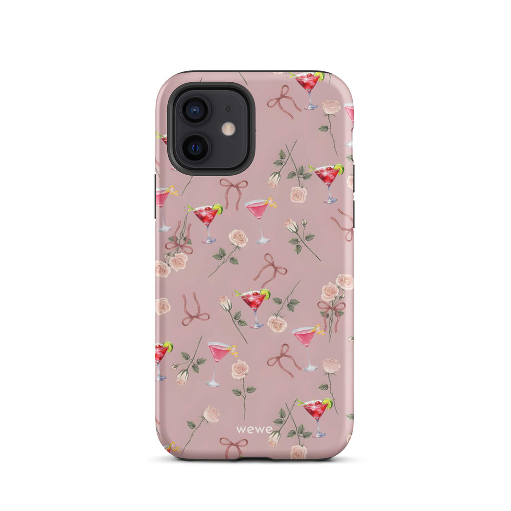 Custom iPhone case 12 with a repeating pattern of pink roses, ribbon bows, and red cocktail glasses on a light rose colour background.