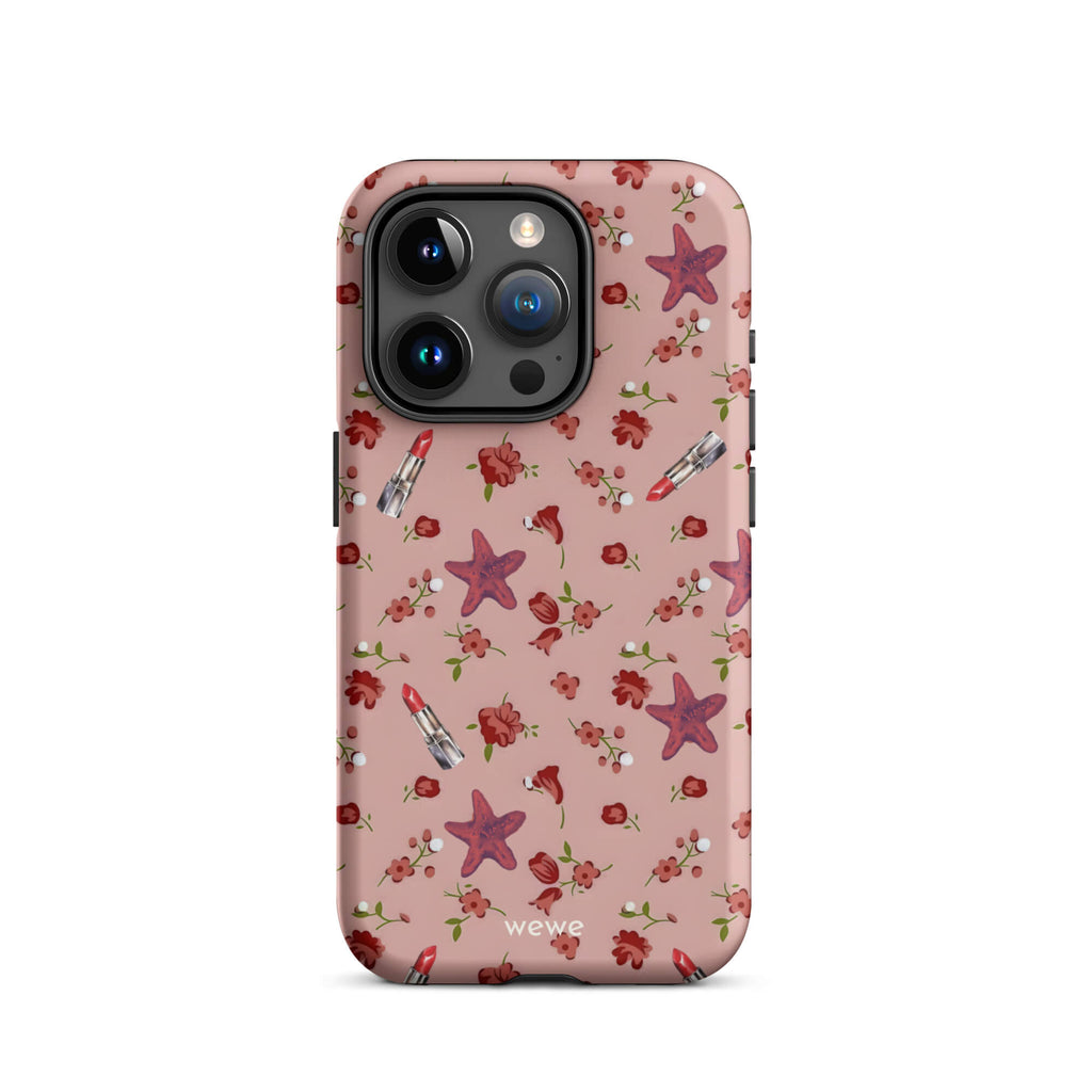 Custom iPhone case 15 pro with a  retro pattern of red flowers, starfish, and lipstick tubes on a pink rose colour background.
