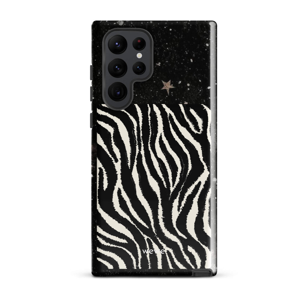 Custom samsung galaxy s22 ultra with a black, glittery cosmic/galaxy top half with stars, and a bold black and white zebra stripe pattern on the bottom half.