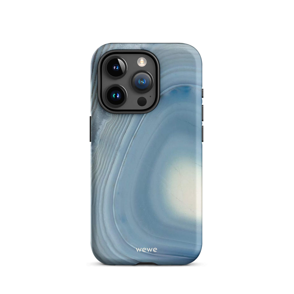 Custom iPhone case 15 pro with a  close-up image of a blue and white geode or agate slice with swirling patterns.