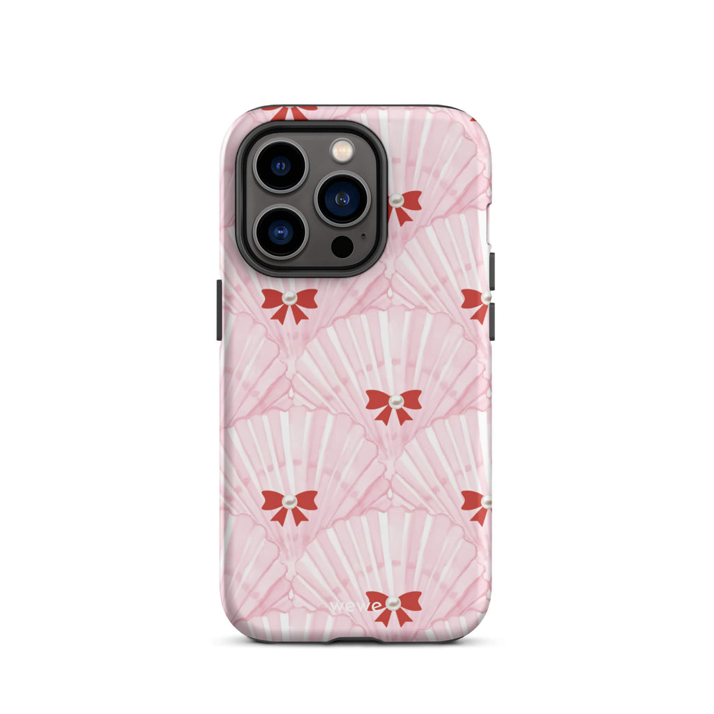 Custom iPhone case 14 pro with a cute and whimsical pattern of watercolor pink and white seashells with red bows and pearls.