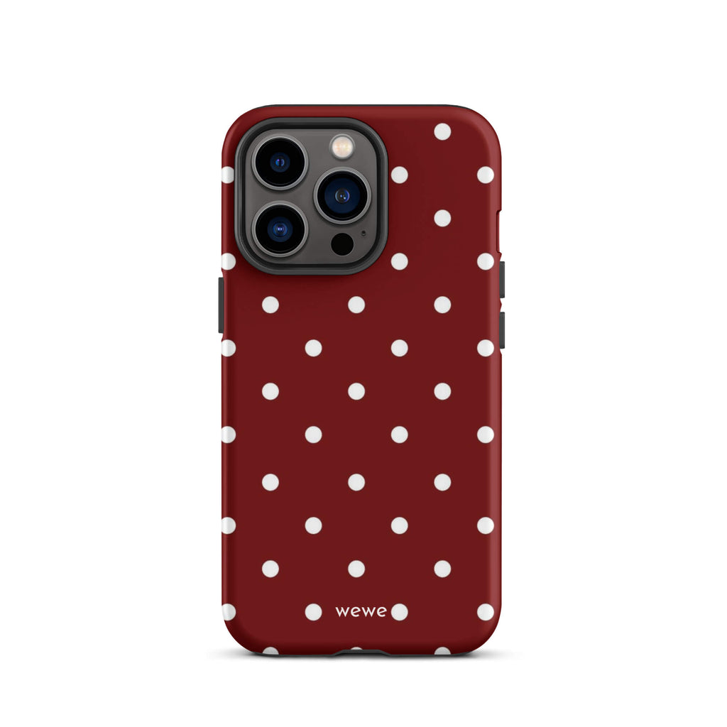 Custom iPhone case 13 pro with a maroon red background and a pattern of small white polka dots.