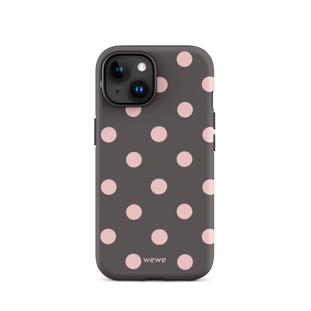 Custom iPhone 15 tough case in matte dark grey/charcoal with large light pink (blush) polka dots and 'wewe' branding at the bottom.